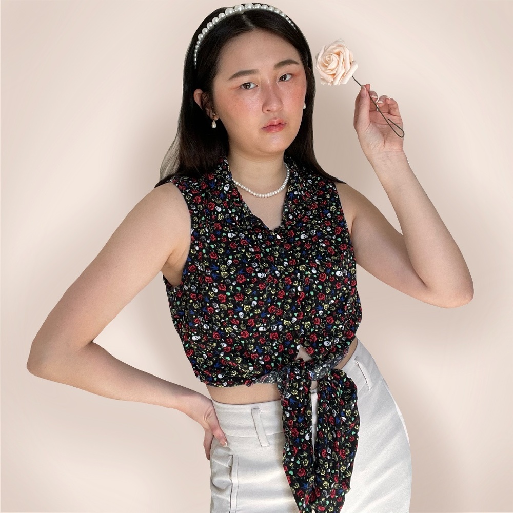 Sleeveless black tie front top ft. floral skull print.